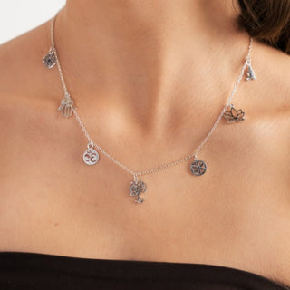 Silver Charm Necklace shown on woman's neck with a close up view from O. Live Love.